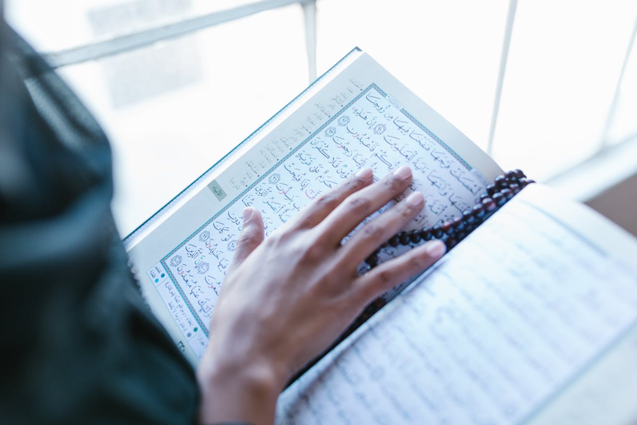 Hand Holding a Quran